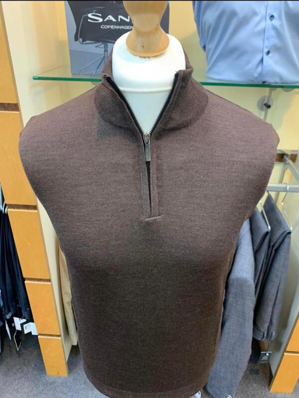 dark camel knitted jumper with a half zip which is slightly undone, upon a manequin